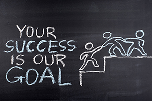 Your Success is our Goal hand drawing on blackboard your success is our goal